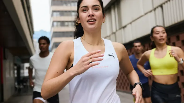 Group of runners training outdoors in an urban setting, focused on pace and performance