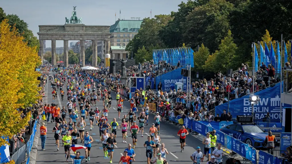 Large group of marathon runners starting the race with energetic atmosphere